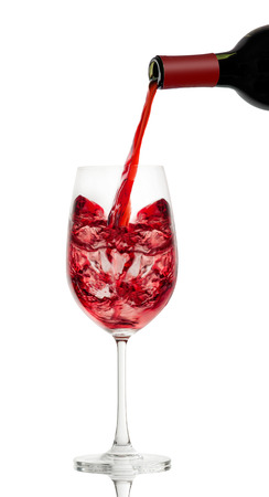 red wine in a glass isolated over white backgroundの写真素材
