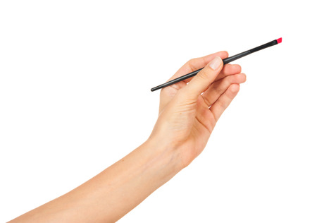 Professional make-up brush cosmetic in female hand beautician isolated on white backgroundの写真素材