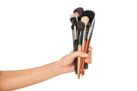 Professional make-up brush cosmetic in female hand beautician isolated on white backgroundの写真素材