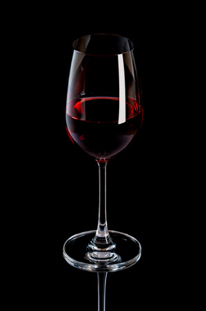 red wine in a glass isolated over white backgroundの写真素材