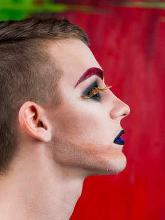 Close-up portrait of the handsome young man fashion model with make-up and big eyelashesの写真素材