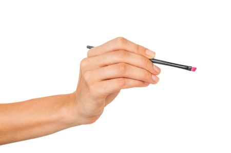 Professional make-up brush cosmetic in female hand beautician isolated on white backgroundの写真素材