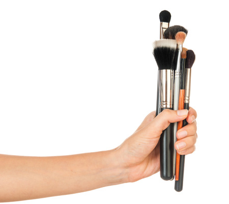 Professional make-up brush cosmetic in female hand beautician isolated on white backgroundの写真素材