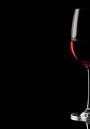 Red wine in a glass isolated over white backgroundの写真素材