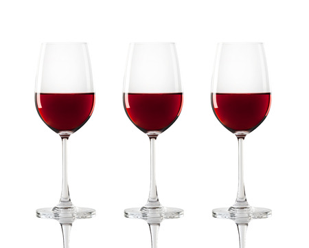 Red wine in a glass isolated over white backgroundの写真素材