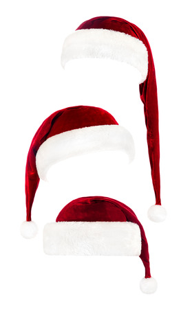 Set of red Santa Claus hats isolated on white backgroundの写真素材