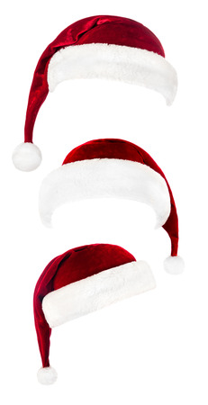 Set of red Santa Claus hats isolated on white backgroundの写真素材