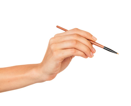 Professional make-up brush cosmetic in female hand beautician isolated on white backgroundの写真素材