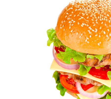 Big beautiful juicy burger with meat and vegetables. Isolated on white backgroundの写真素材