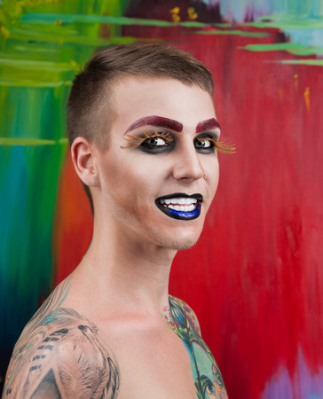 Close-up portrait of the handsome young man fashion model with make-up and big eyelashesの写真素材