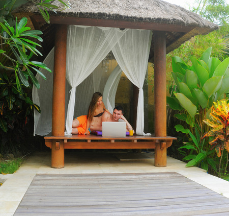 Happy smiling couple surfing internet  and enjoy the summerの写真素材