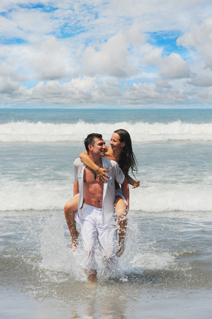 Young beautiful couple in love on a sunny beachの写真素材