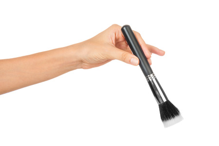 Professional make-up brush cosmetic in female hand beautician isolated on white backgroundの写真素材