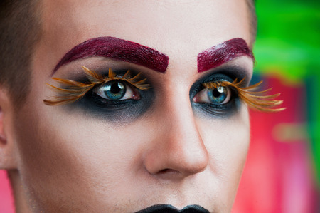 Close-up portrait of the handsome young man fashion model with make-up and big eyelashesの写真素材