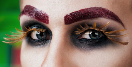 Close-up portrait of the handsome young man fashion model with make-up and big eyelashesの写真素材