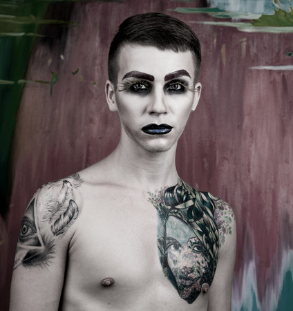 Close-up portrait of the handsome young man fashion model with make-up and big eyelashesの写真素材