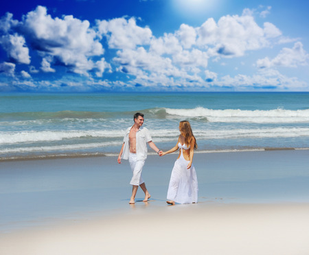 Young beautiful couple in love on a sunny beachの写真素材