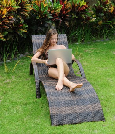 Happy smiling woman surfing internet  and enjoy the summerの写真素材