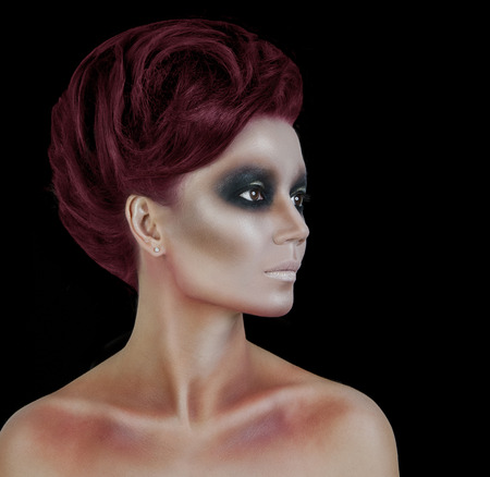 Professional Make up concept. Portrait of young beautiful woman with beauty makeup and perfect skin. Isolated on black backgroundの写真素材