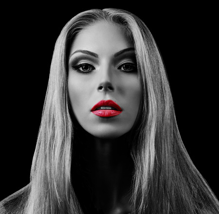 Professional Make up concept. Portrait of young beautiful woman with beauty makeup and perfect skin. Isolated on black backgroundの写真素材