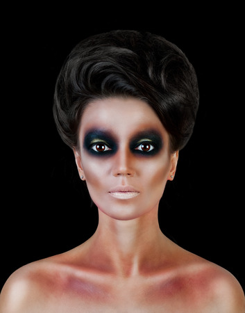 Professional Make up concept. Portrait of young beautiful woman with beauty makeup and perfect skin. Isolated on black backgroundの写真素材