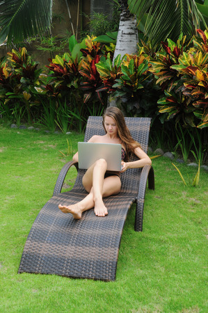 Happy smiling woman surfing internet  and enjoy the summerの写真素材