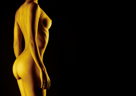 Sexy body nude woman. Naked sensual buttocks isolated on blackの写真素材