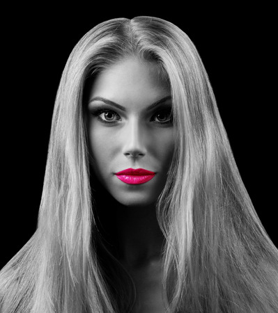 Professional Make up concept. Portrait of young beautiful woman with beauty makeup and perfect skin. Isolated on black backgroundの写真素材