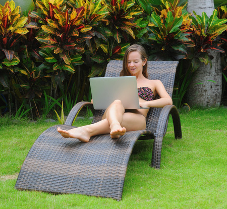 Happy smiling woman surfing internet  and enjoy the summerの写真素材