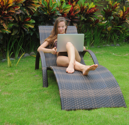 Happy smiling woman surfing internet  and enjoy the summerの写真素材