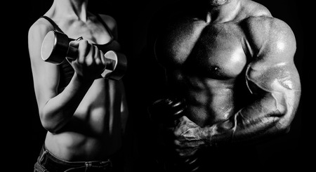 Bodybuilding. Strong man and a woman posing on a black backgroundの写真素材
