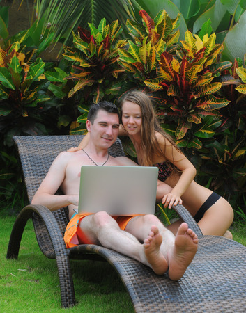 Happy smiling couple surfing internet  and enjoy the summerの写真素材