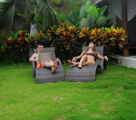 Happy smiling couple surfing internet  and enjoy the summerの写真素材