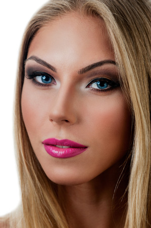 Professional Make up concept. Portrait of young beautiful woman with beauty makeup and perfect skin. Isolated on white backgroundの写真素材