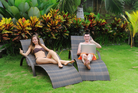 Happy smiling couple surfing internet  and enjoy the summerの写真素材