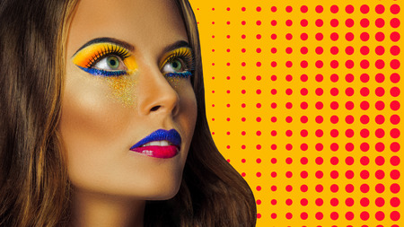 Professional Make up concept. Portrait of young beautiful woman with beauty makeup and perfect skin. on color backgroundの写真素材