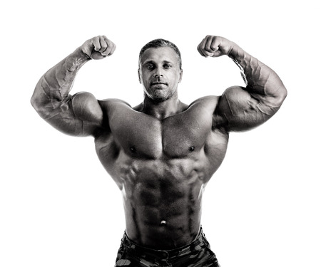 bodybuilder posing. Handsome power athletic guy male. Fitness muscular body.  Isolated on white backgroundの写真素材