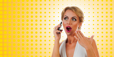 Portrait happy young woman talking on mobile phone on color backgroundの写真素材