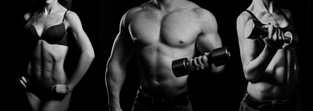 Bodybuilding. Strong man and a woman posing on a black backgroundの写真素材