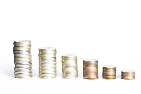stacks of coins from largest to smallest in perspective and shadows on a white background. High quality photoの写真素材