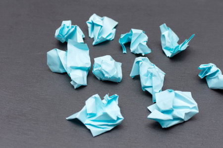crumpled blue papers on a dark background. High quality photoの写真素材