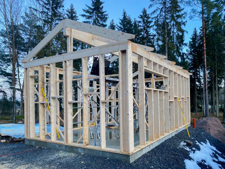 Wooden frame of a house under construction on a universal Swedish plate. High quality photoの写真素材