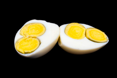 egg with two yolks on a black background.の写真素材