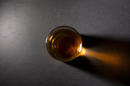 glass with whiskey on a dark background top view. High quality photoの写真素材
