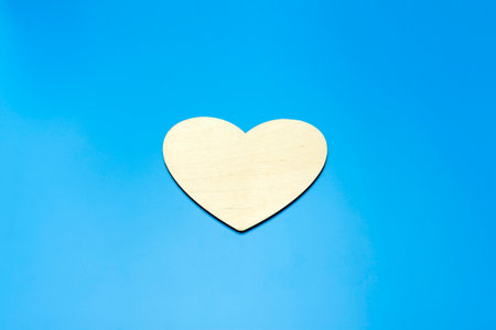 wooden heart on a blue background close up. High quality photoの写真素材