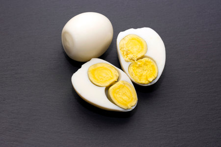 egg with two yolks on a black background. High quality photo