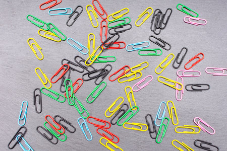 colored paper clips on a dark background. High quality photoの写真素材