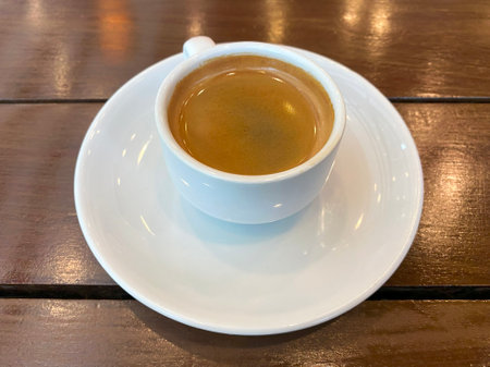 A cup of espresso coffee on a wooden table. High quality photoの写真素材