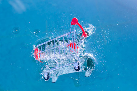 a shopping cart falls into the water and sinks. concept. High quality photoの写真素材