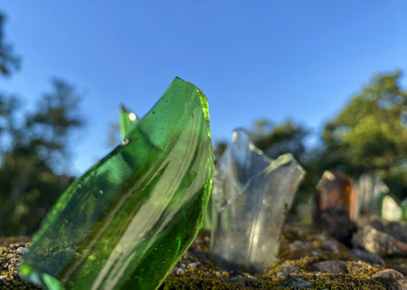 broken glass bottles on the fenceの写真素材